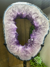 Load image into Gallery viewer, Amethyst Crystal geode slice on black display stand