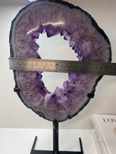 Load image into Gallery viewer, Amethyst Crystal geode slice on black display stand