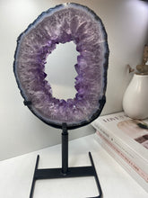 Load image into Gallery viewer, Amethyst Crystal geode slice on black display stand