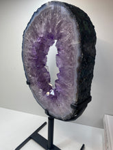 Load image into Gallery viewer, Amethyst Crystal geode slice on black display stand