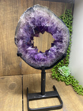 Load image into Gallery viewer, Amethyst Crystal geode slice on black display stand