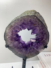 Load image into Gallery viewer, Amethyst Crystal geode slice on black display stand