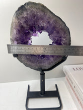 Load image into Gallery viewer, Amethyst Crystal geode slice on black display stand