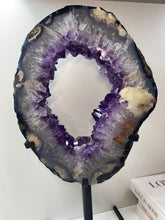 Load image into Gallery viewer, Amethyst Crystal geode slice on black display stand