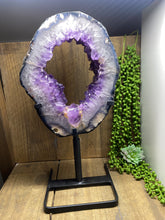 Load image into Gallery viewer, Amethyst Crystal geode slice on black display stand