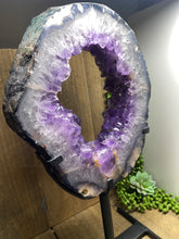 Load image into Gallery viewer, Amethyst Crystal geode slice on black display stand