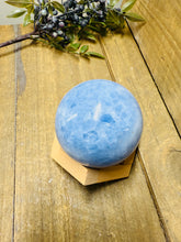 Load image into Gallery viewer, Natural Blue Calcite sphere on wooden stand