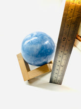 Load image into Gallery viewer, Natural Blue Calcite sphere on wooden stand