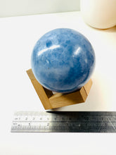 Load image into Gallery viewer, Natural Blue Calcite sphere on wooden stand