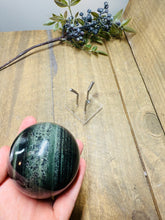 Load image into Gallery viewer, Green Hair Jasper sphere on stand