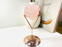Load image into Gallery viewer, Polished Rose Quartz love heart on rose colored metal stand with zodiac sign