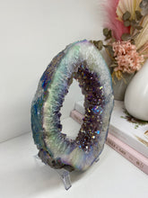 Load image into Gallery viewer, Titanian coated Amethyst Crystal geode slice on display stand