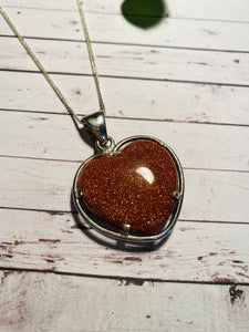 Gold stone heart shaped pendant set in sterling silver