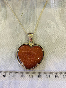 Gold stone heart shaped pendant set in sterling silver