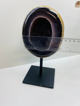 Load image into Gallery viewer, Large Natural Agate Geode with Quartz crystals inside on black stand