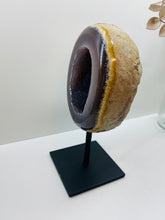Load image into Gallery viewer, Large Natural Agate Geode with Quartz crystals inside on black stand