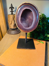 Load image into Gallery viewer, Large Natural Agate Geode with Quartz crystals inside on black stand