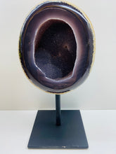 Load image into Gallery viewer, Large Natural Agate Geode with Quartz crystals inside on black stand