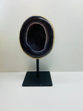 Load image into Gallery viewer, Large Natural Agate Geode with Quartz crystals inside on black stand