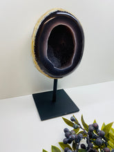 Load image into Gallery viewer, Large Natural Agate Geode with Quartz crystals inside on black stand