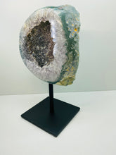 Load image into Gallery viewer, Large Natural Agate Geode with Quartz crystals inside on black stand