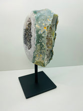 Load image into Gallery viewer, Large Natural Agate Geode with Quartz crystals inside on black stand