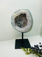 Load image into Gallery viewer, Large Natural Agate Geode with Quartz crystals inside on black stand