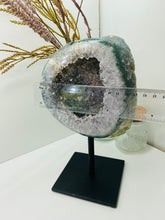 Load image into Gallery viewer, Large Natural Agate Geode with Quartz crystals inside on black stand
