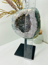 Load image into Gallery viewer, Large Natural Agate Geode with Quartz crystals inside on black stand