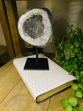 Load image into Gallery viewer, Large Natural Agate Geode with Quartz crystals inside on black stand
