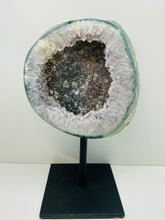 Load image into Gallery viewer, Large Natural Agate Geode with Quartz crystals inside on black stand