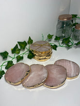 Load image into Gallery viewer, Rose Quartz slice drink coasters with gold electroplating around the edges