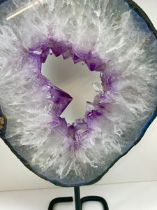 Amethyst Crystal geode slice on black display stand