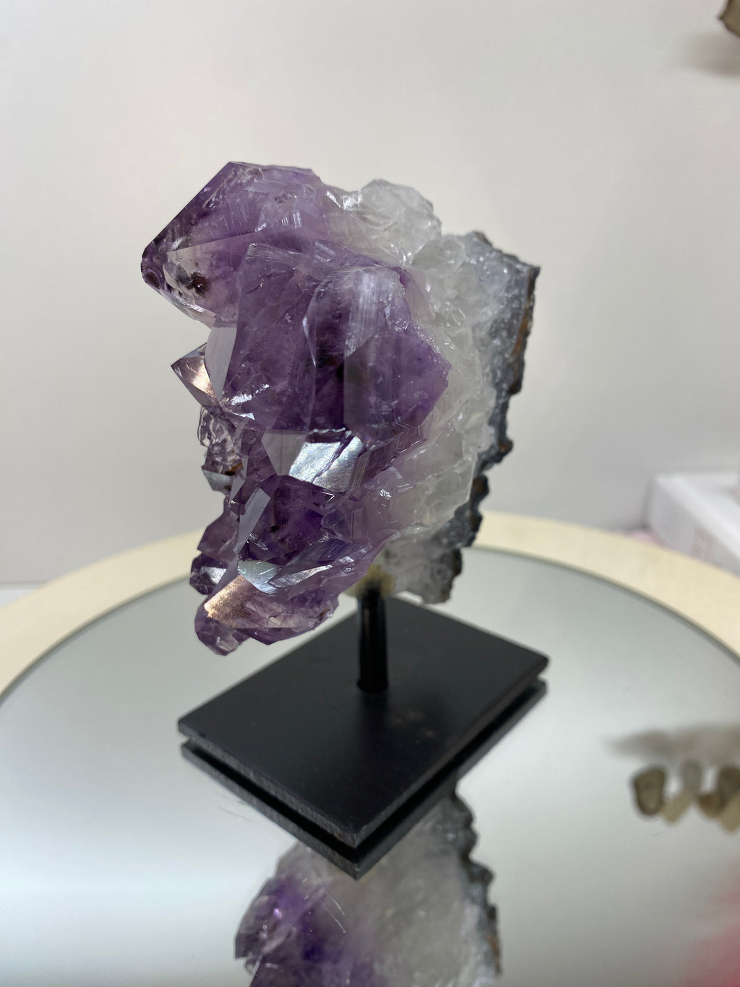 Amethyst Crystal on black display stand