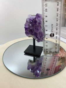 Amethyst Crystal on black display stand