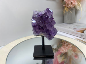 Amethyst Crystal on black display stand