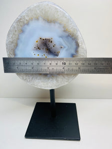 Large Natural Agate Geode with Quartz crystals inside on black stand