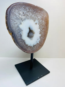 Large Natural Agate Geode with Quartz crystals inside on black stand