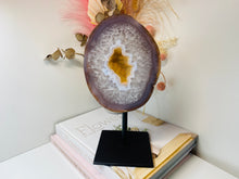 Load image into Gallery viewer, Large Natural Agate Geode with Quartz crystals inside on black stand