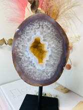 Load image into Gallery viewer, Large Natural Agate Geode with Quartz crystals inside on black stand