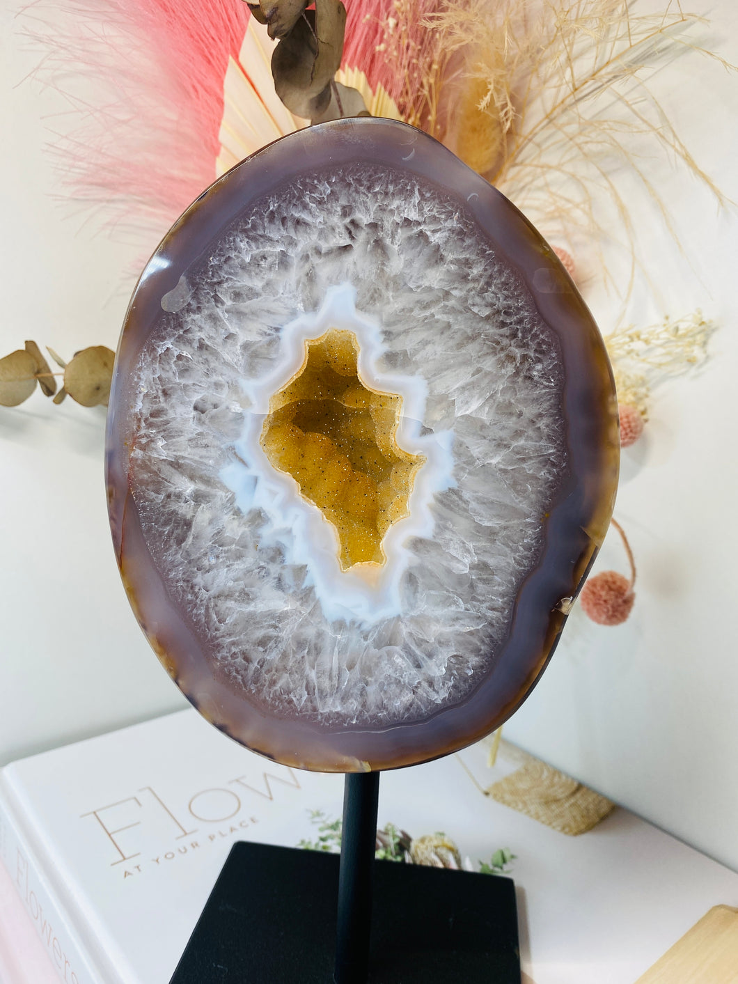 Large Natural Agate Geode with Quartz crystals inside on black stand