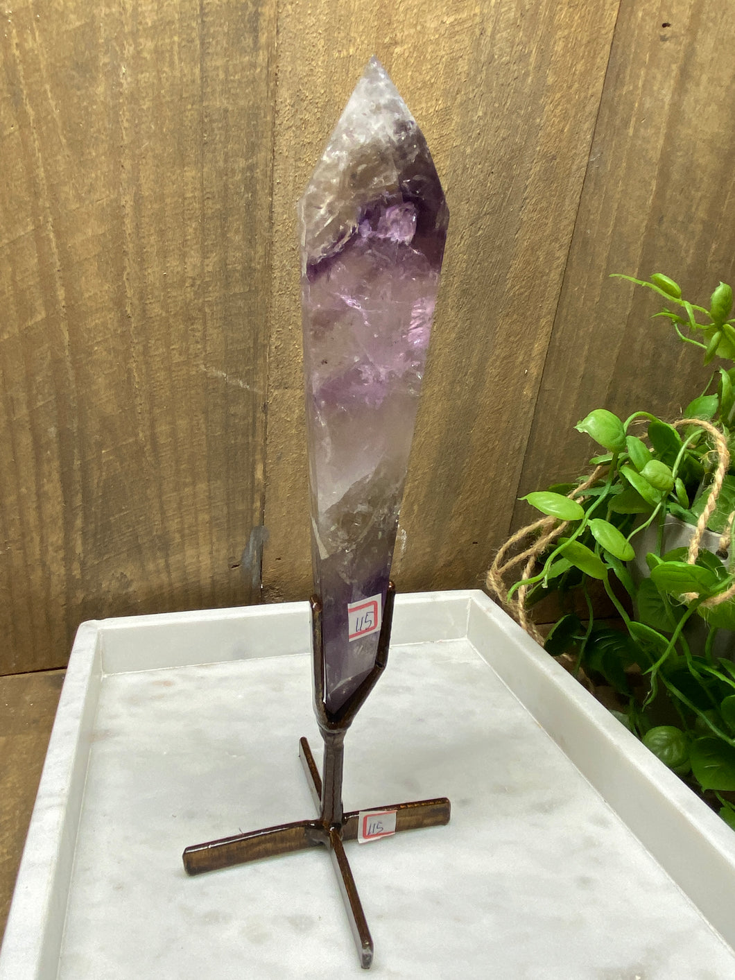 Phantom Amethyst point on display stand