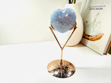 Load image into Gallery viewer, Polished Blue Calcite love heart on rose colored metal stand with zodiac sign