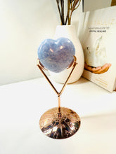 Load image into Gallery viewer, Polished Blue Calcite love heart on rose colored metal stand with zodiac sign