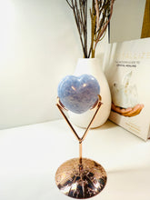 Load image into Gallery viewer, Polished Blue Calcite love heart on rose colored metal stand with zodiac sign