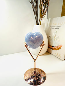 Polished Blue Calcite love heart on rose colored metal stand with zodiac sign