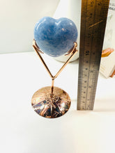 Load image into Gallery viewer, Polished Blue Calcite love heart on rose colored metal stand with zodiac sign