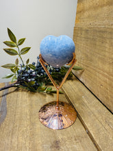 Load image into Gallery viewer, Polished Blue Calcite love heart on rose colored metal stand with zodiac sign