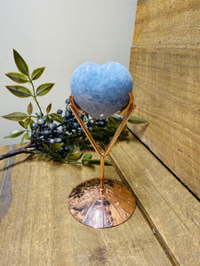 Polished Blue Calcite love heart on rose colored metal stand with zodiac sign