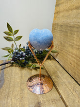 Load image into Gallery viewer, Polished Blue Calcite love heart on rose colored metal stand with zodiac sign